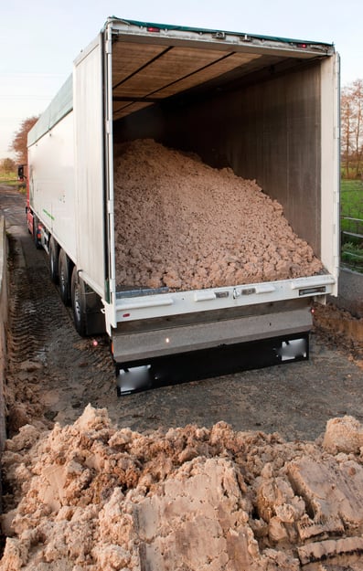 A moving floor trailer loaded with bulk material