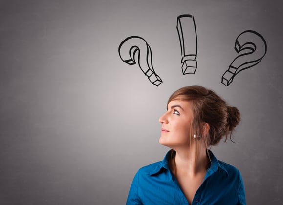 Woman shown looking up thoughtfully with question marks and an exclamation point above her head