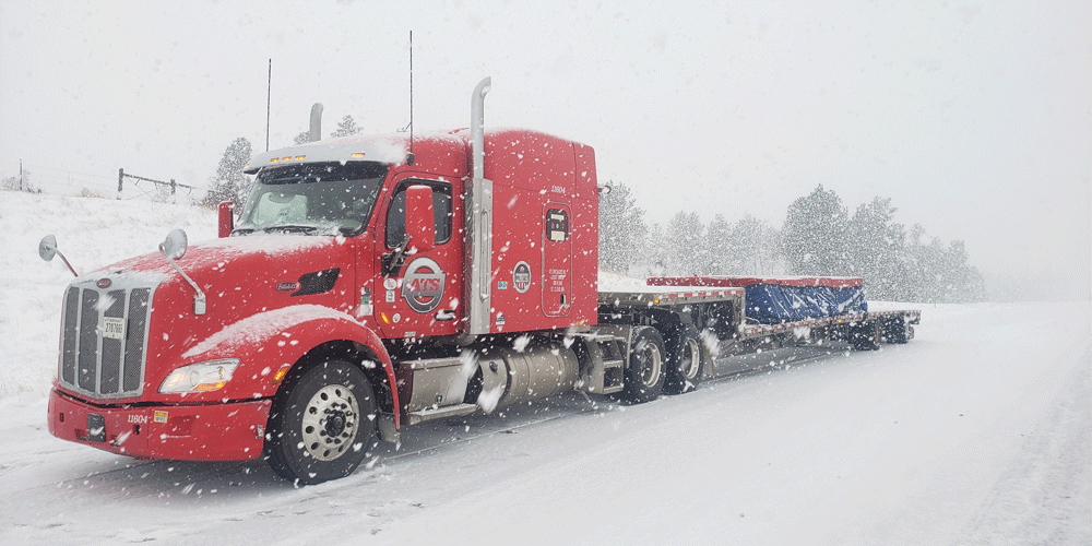 Truck pulling tarped load in the snow