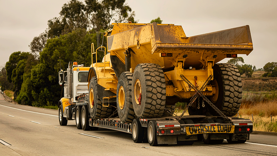 Lowboy Trailer Hauling Construction Equipment