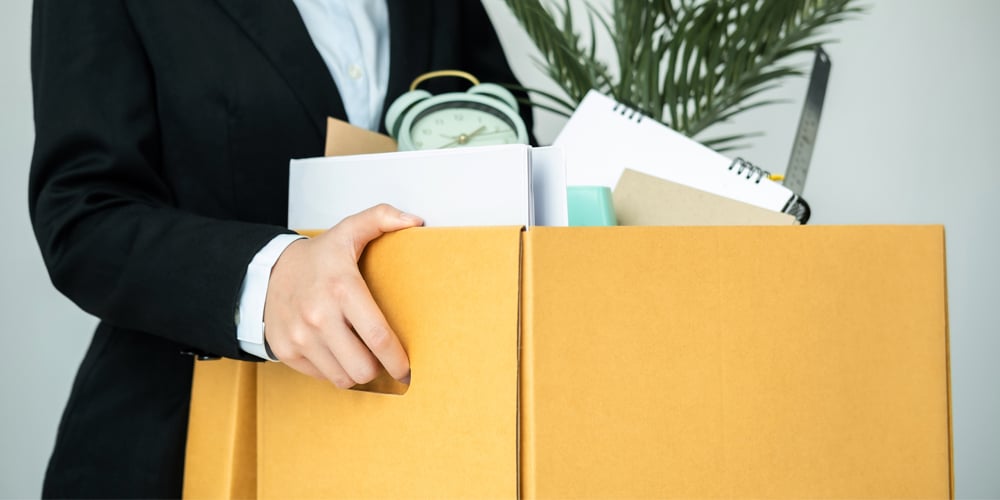 Employee quit and carrying out box of personal items