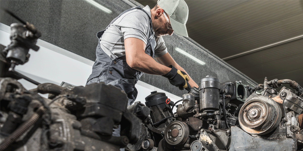 Diesel mechanic working on an engine.