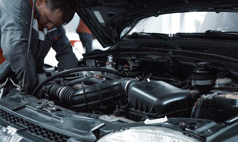 Automotive-technician-working-on-car-engine