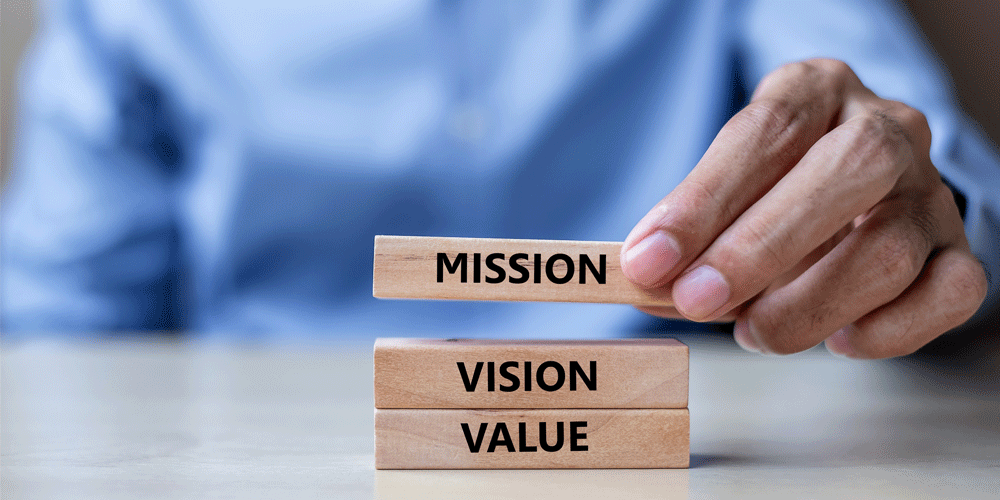 an stacking wood blocks that read Mission, Vision, Value