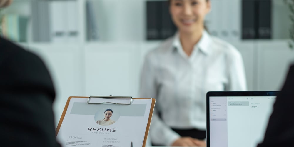 Woman gives resume to HR manager