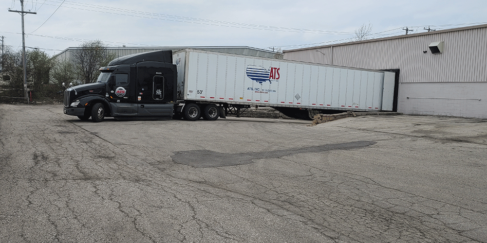 Dry van trailer backed up to a loading dock
