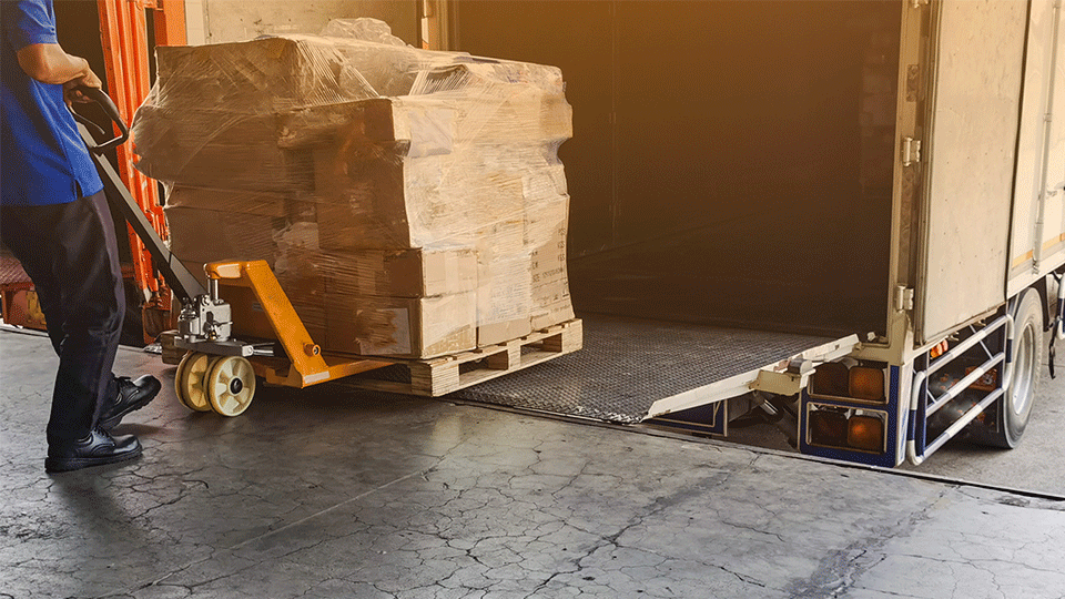 Man-with-pallet-jack-loading-pallet-on-truck
