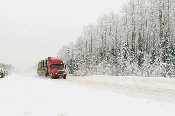 semi-driving-on-snow-covered-highway