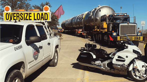 ATS escort car leading ATS semi hauling oversize freight. Memorial Day 2026 shipping restrictions