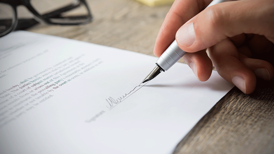Logistics-professional-signing-contract-in-pen