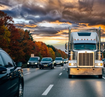 Semi-truck driving along highway in busy traffic. Memorial Day 2026 shipping restrictions