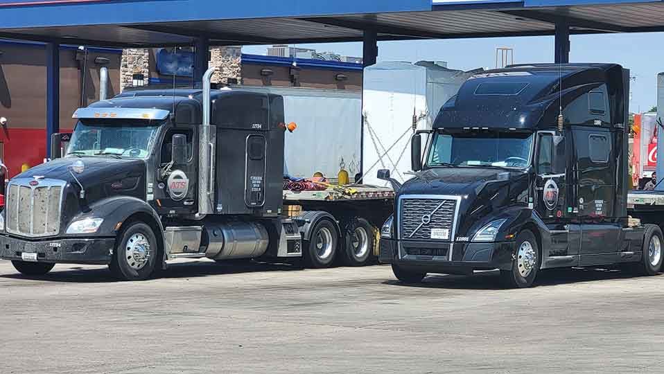 two semi tractors at truck stop