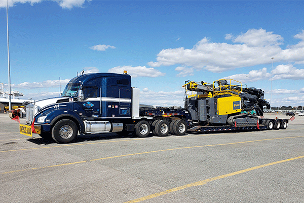 Flatbed trailer with construction equipment