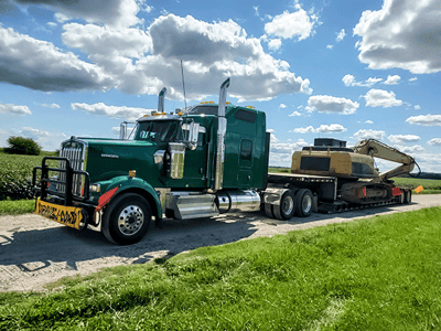 Double Drop RGN Trailer With Construction Equipment