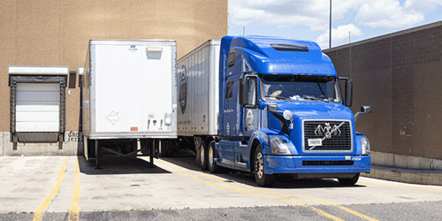 Blue semi with van trailer at leading retailer