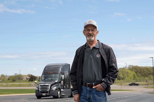 Truck-Driver-Standing-in-front-of-Truck