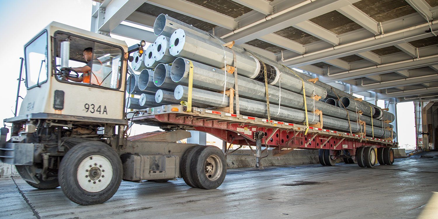 Flatbed trailer being loaded onto a roll-on/roll-off (Ro/Ro) vessel
