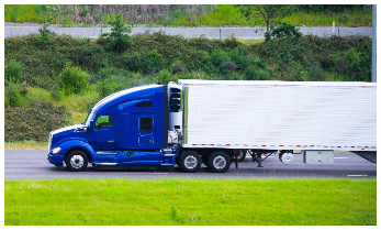 Modern dark blue semi truck reefer trailer profile on green road