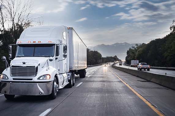 Dry van semi truck on highway 