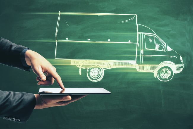 Close up of hand tapping on a tablet device with an illustration of a truck being dispatched