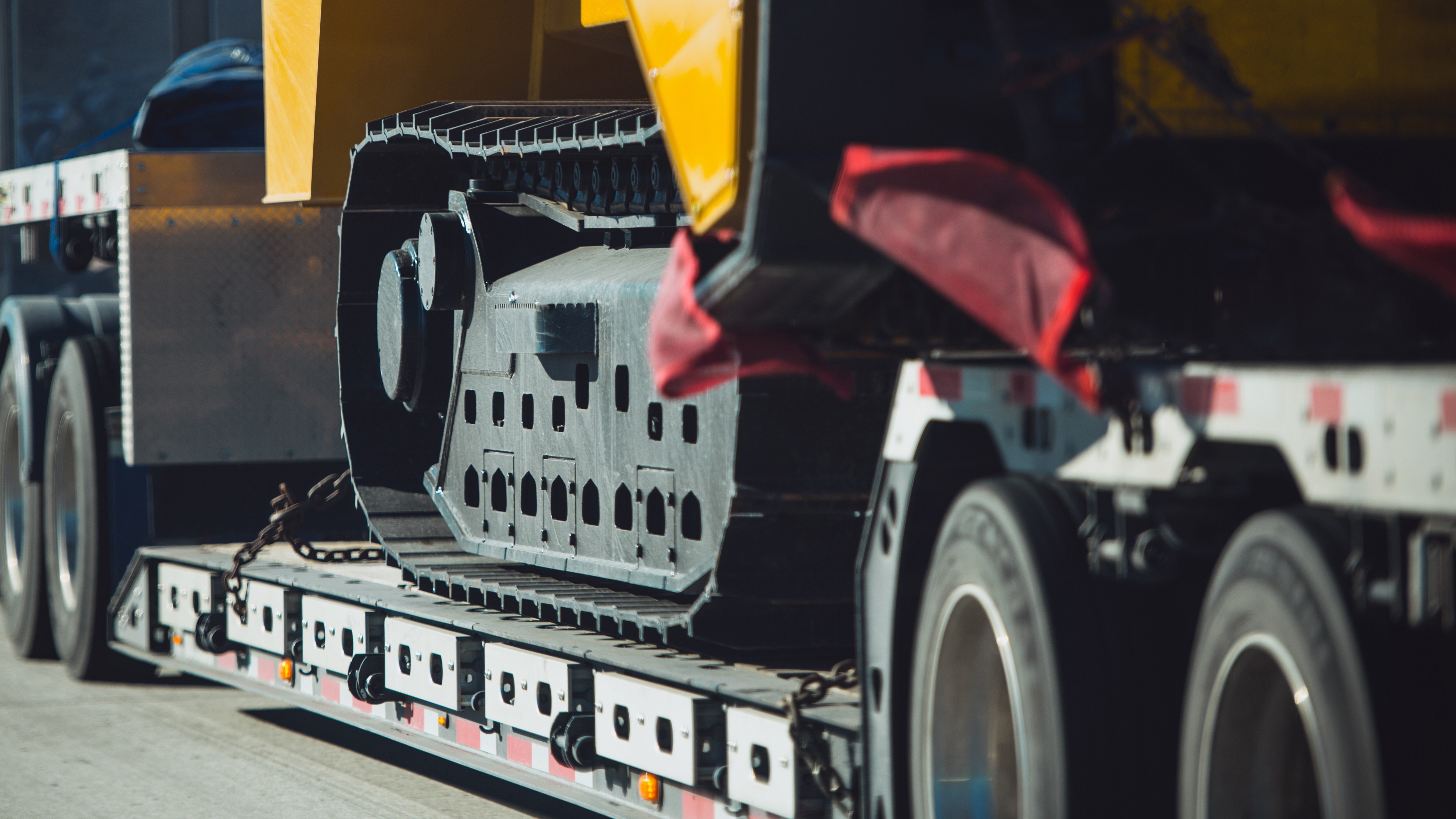 flatbed-trailer-transporting-construction-equipment-1