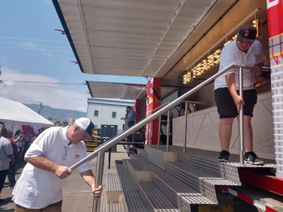 ATS Driver helps assemble stairs for container bar