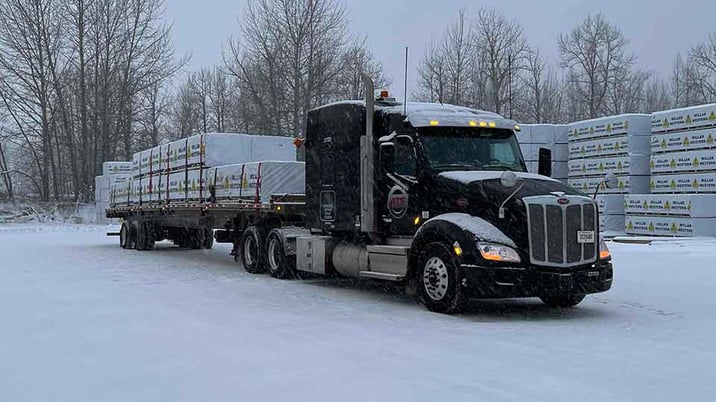 Tarped flatbed freight on an ATS truck in the winter.