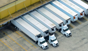 Several dry van trucks and trailers at a distribution center