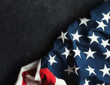 American flag draped across black table