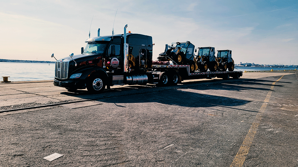 step-deck-shipment-construction-machinery