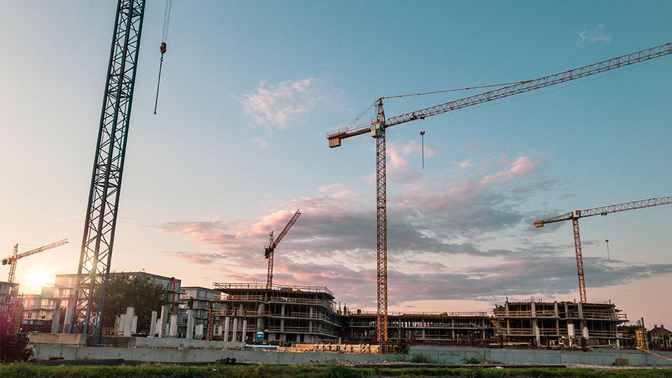 Industrial Building Job Site With Four Cranes 