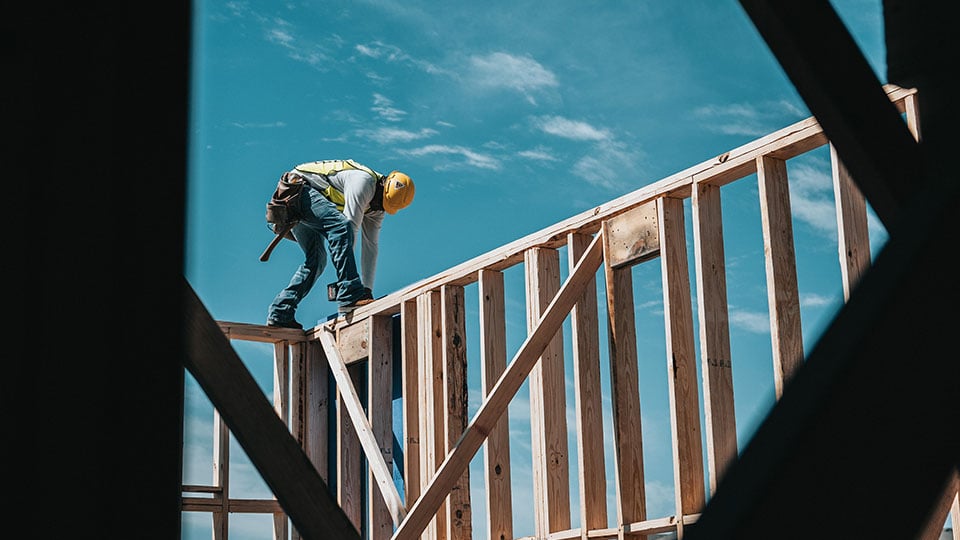 Construction Worker Framing Up a House