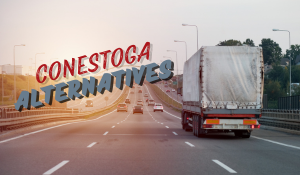Truck with conestoga trailer traveling on highway