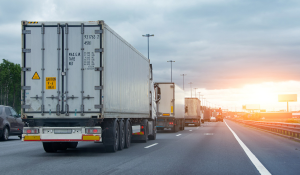 Semi trucks sit in traffic