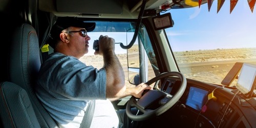 Truck Driver on Radio Inside Cab