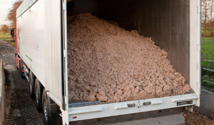 A moving floor trailer loaded with bulk materials
