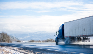 A reefer truck travels on a mountainside road
