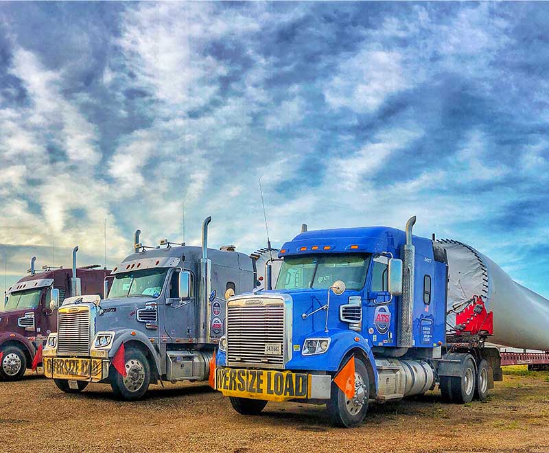Three-semi-trucks-at-job-site