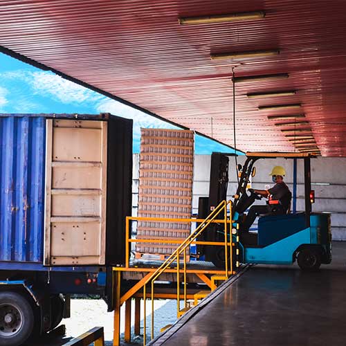 blue container being unloaded pallets of cans on forklift