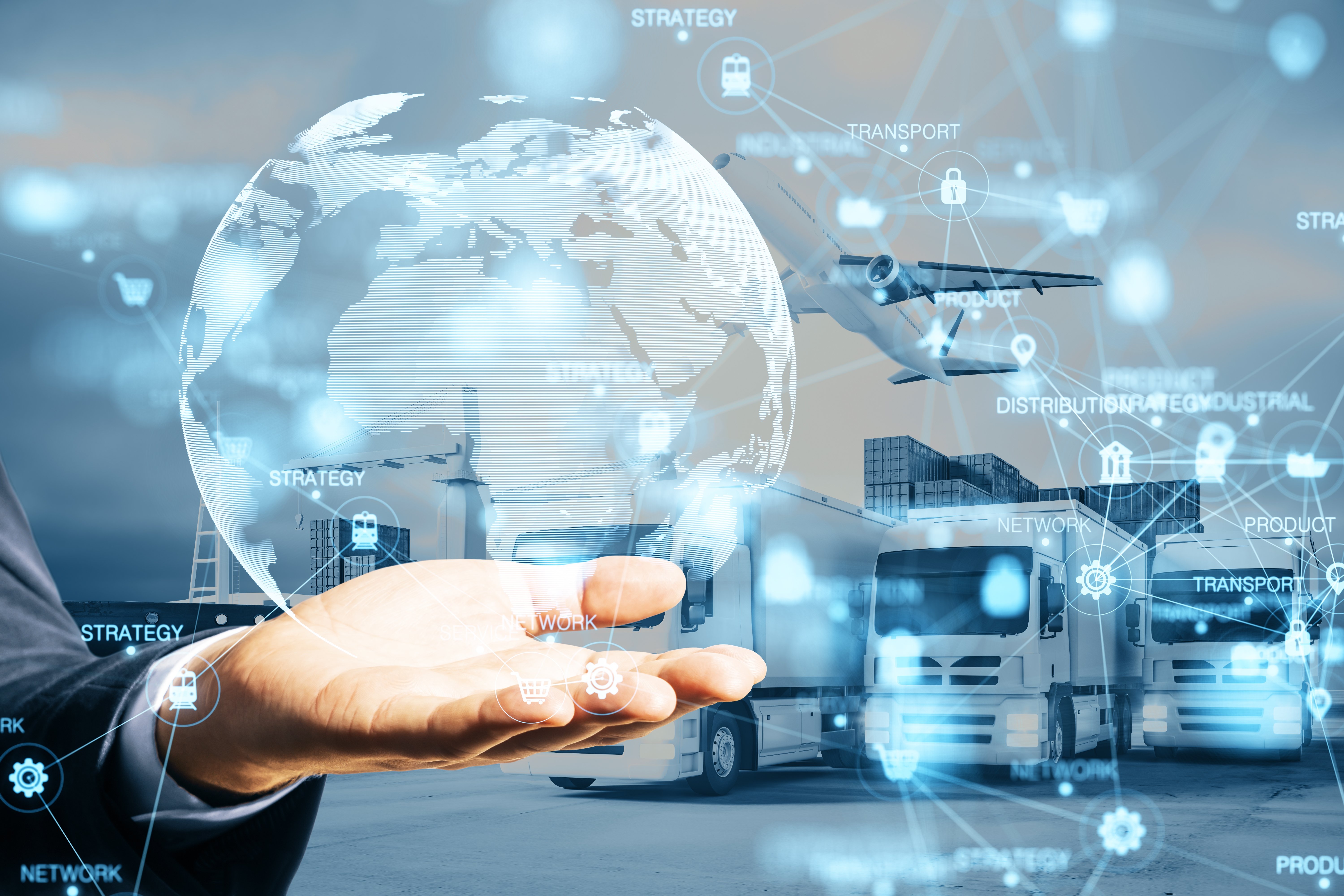 An outstretched hand holding a digital abstraction of the globe and a logistics map against a background of transportation modes.